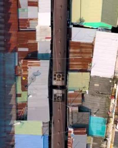 Train passing through Maeklong Railway Market in Bangkok.