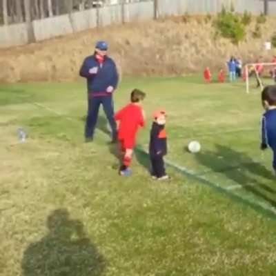 This kid hugging his little brother during the game