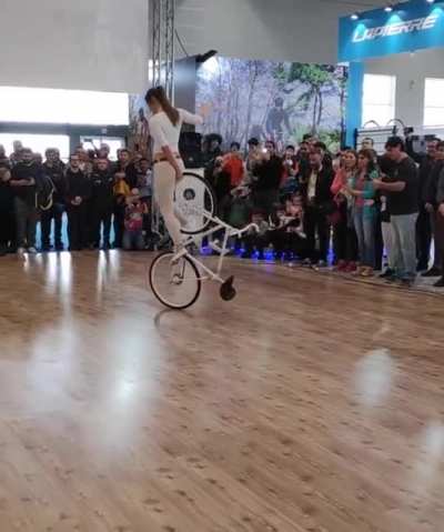 Woman does some impressive bicycle tricks.
