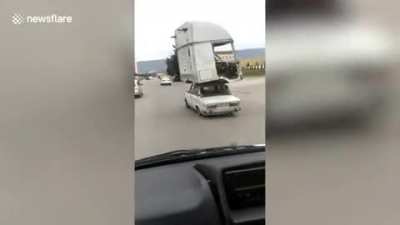 Old Lada driving with a lorry cabin on its roof