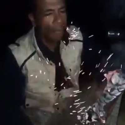 man eats burning wood