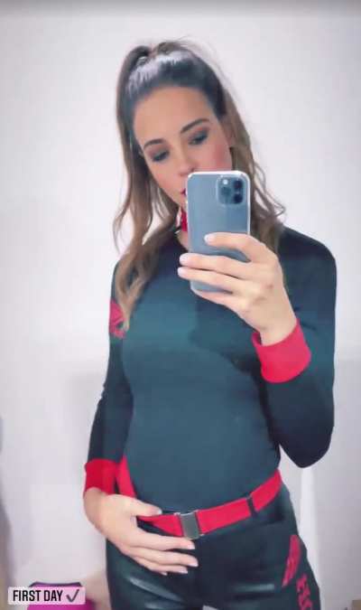 Promo model flashes that big beautiful smile after checking herself out