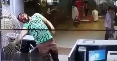 Man casually touches the fan and gets electrocuted.