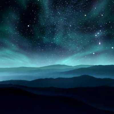 The colors that appear in an Aurora Borealis are determined by the type of gas that electrons come in contact with and how much energy is exchanged.