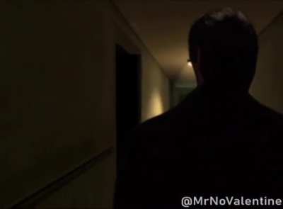 Patrick Bateman walks through an apartment hallway in City17