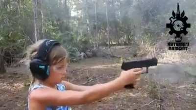 “Girl simultaneously shooting with both hands at targets. It’s obvious she is growing up in a healthy safe family and spends a lot of time with her parents. Very cool.”