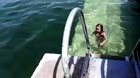 Dolphin takes a little girl on a ride around the pool