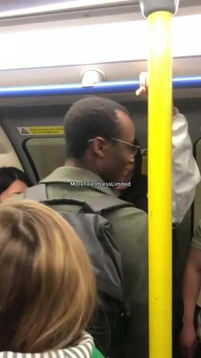 Guy with a megaphone having fun on the London Tube