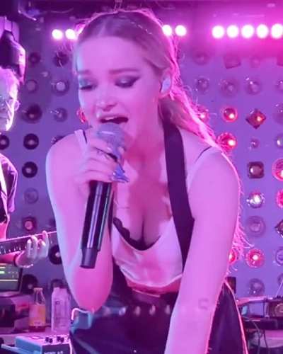 Dove Cameron bending over at her concert.
