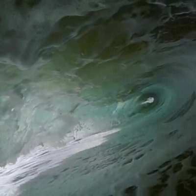 Wave devours the photographer