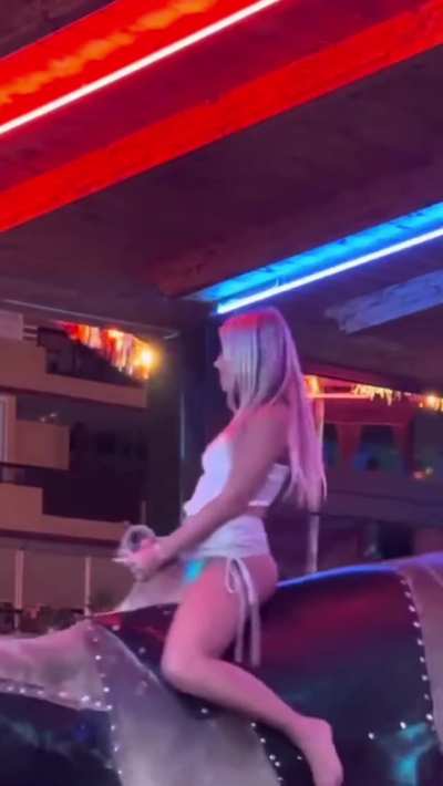 Hot Blonde Girl Riding the Bull in a White Skirt