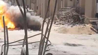 Al Qassam brigade (Hamas) sappers dash across a open road from a alleyway and plant 2 IED's on a Merkava before running to cover 