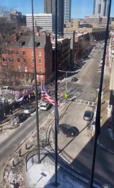 Patriot Front marching towards Government Center in Boston, followed by a counter protestor chanting 
