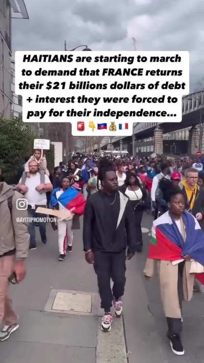 Haitians protesting in France snd calling for reparations.