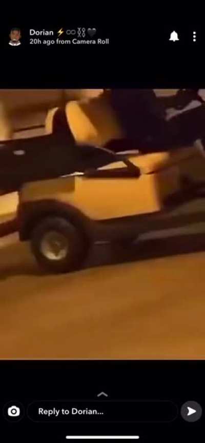 Dude drives golf cart in a lot