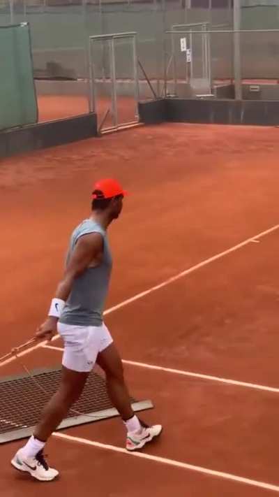 After practicing, Rafael Nadal doesn't forget to fix the court. Classy.