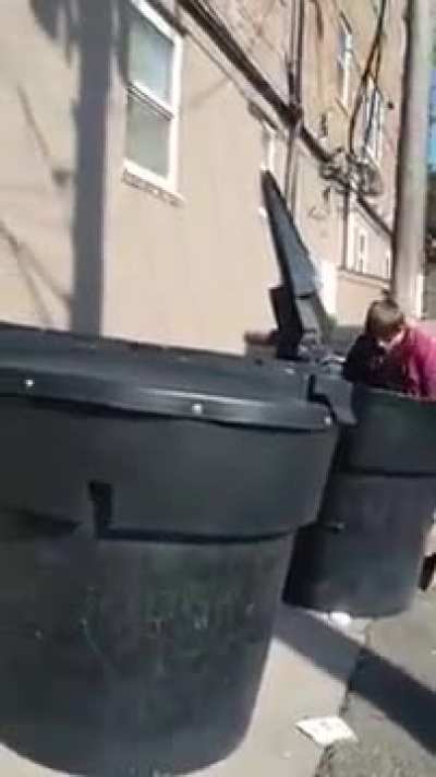 Man chilling in trash can, doesn't want to get out