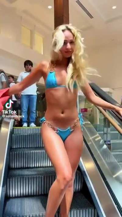 Woman gets 90% naked on an escalator then says the guy in the back froze , in the comments