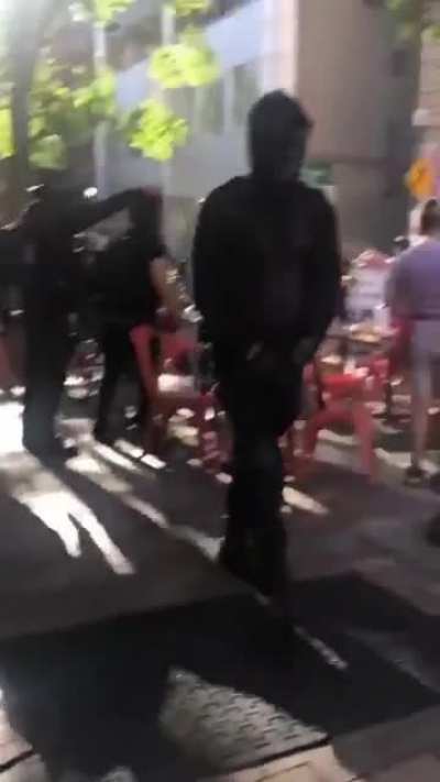BLM marchers go into outdoor dining area & eat patrons food of their table.