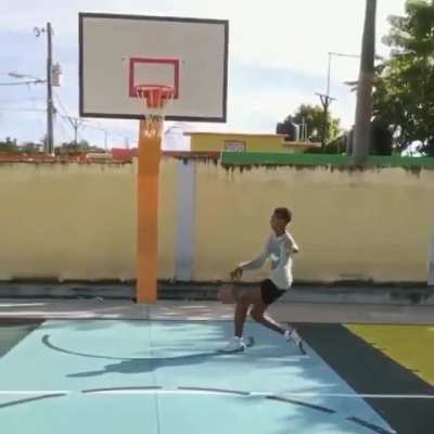 This young basketball player in the Dominican Republic spectacularly dunks with his one arm.