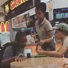 Fast food worker helping a disabled person to eat food