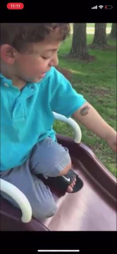 Frog on a kid on a slide in the park