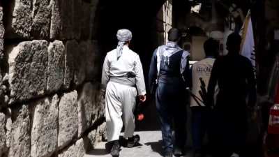 Members of Ansar Al Islam walking through Damascus old neighborhoods while chanting Ma Wahna