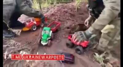 RU pov Russian soldiers in Ukraine passing the time by playing with dump trucks and tractors