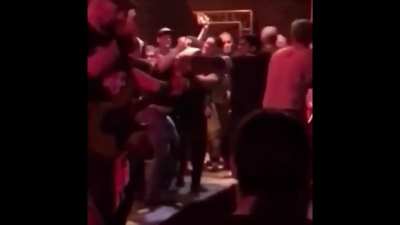 Neo-nazi idiots showed up to a left-wing punk concert, and got beat up on stage. The band continued to play music :)