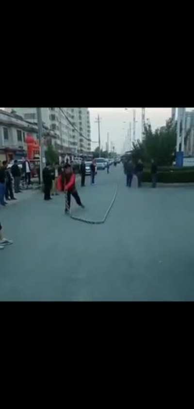 Man whips a massive chain