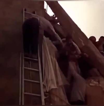 Little Iranian boy waves to cheering crowd during rescue from rubble after US-Israeli strikes