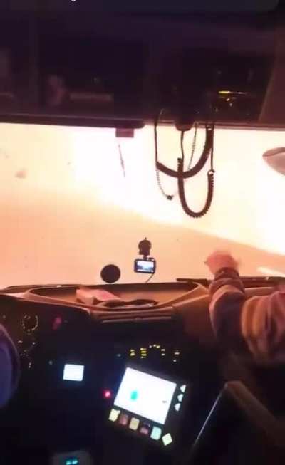 Chilean firefighters drive through the fire and find a bus with people inside.