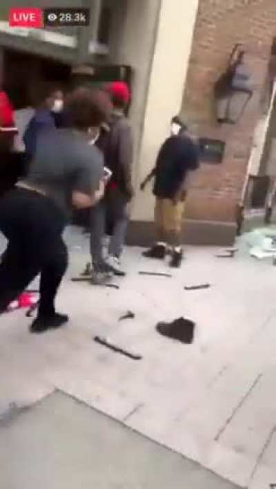 Woman parks her nice car in the middle of a busy street to stop and join looters and picks up a couple pairs of free shoes