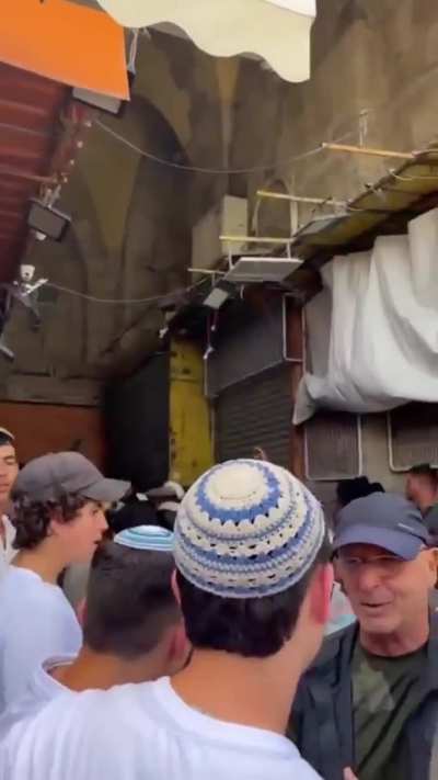 Tensions rise in Jerusalem's Old City as nationalist youth encounter shopkeepers and peace activists (visible in purple vest)