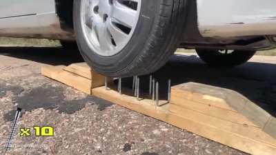 Inside view of a car tire while it's being punctured