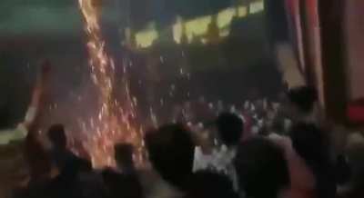 Fans bursting firecrackers during screening of a film in India.