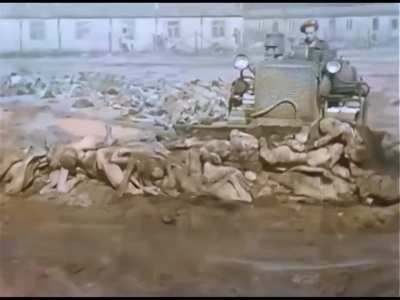 Bergen-Belsen concentration camp. | Colorized and restored footage of a tractor pushing dead concentration camp inmates into a pit.