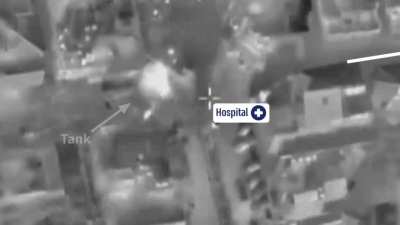 Hamas militant fires a rpg from an entrance of the 