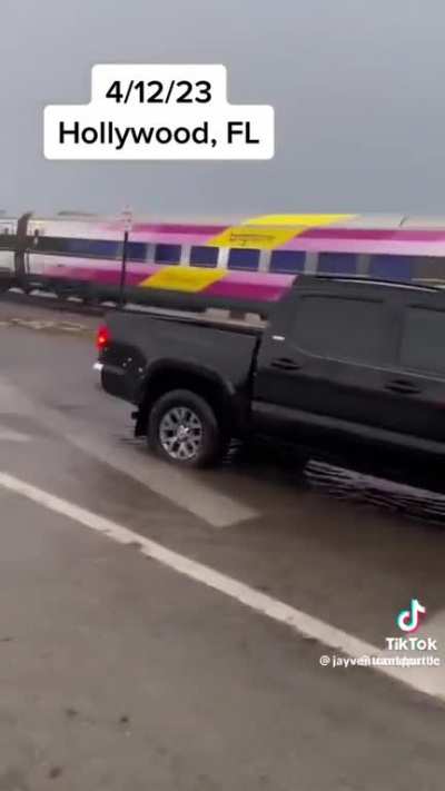Truck carrying trailer full of cars is hit by train in Florida