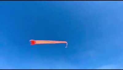 Kid being brought up into the sky by a kite
