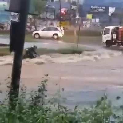 Motorcycle versus road river