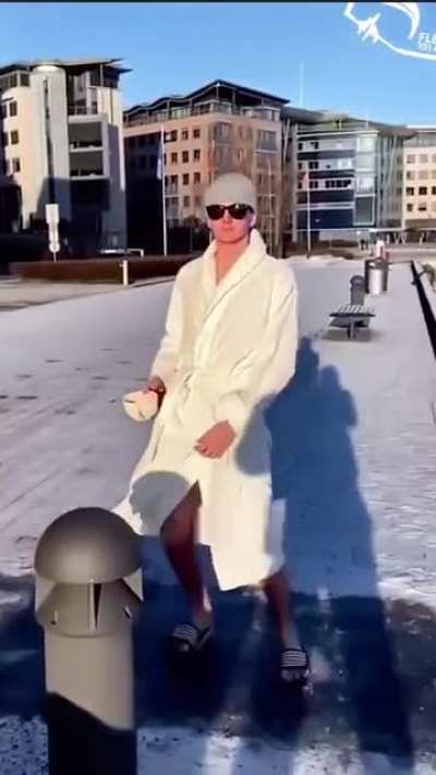 Dude slide on icy ground and jump in the lake with style
