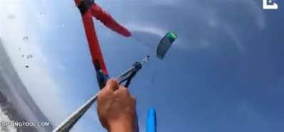 Kitsurfer tries and fails to jump over a median of pointy rocks