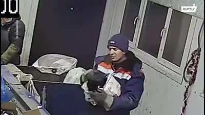 Guy sorting garbage saves a cat that was sealed in a bag and thrown away
