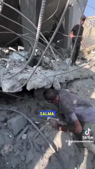 An emotionally shattered man looks for his four children under the rubble in Gaza.