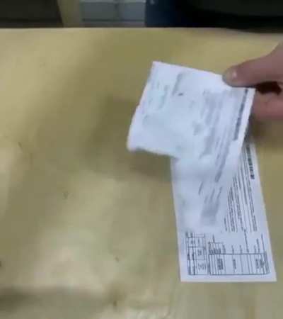 Remove taped paper without tearing it.