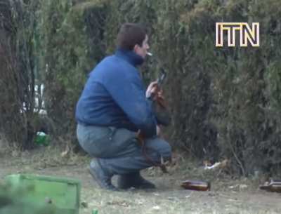 Romanian revolutionary engages Ceausescu loyalists in Bucharest, 12/23/1989
