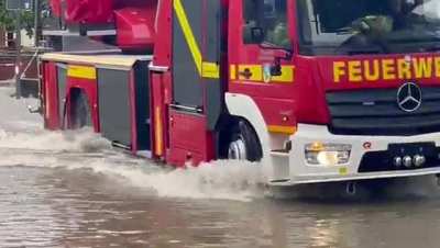 A firetruck responding to an emergency call during the ongoing floods in germany loses its axle.