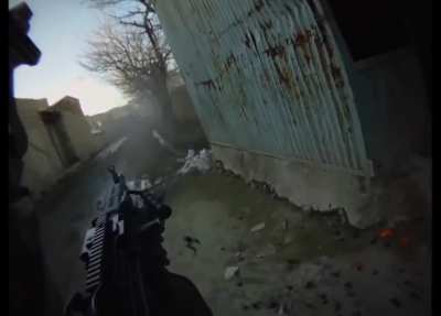 GoPro footage follows a M249 SAW gunner as he and US troops cross a small bridge and lay down suppressive fire. (Afghanistan, Date Unknown)