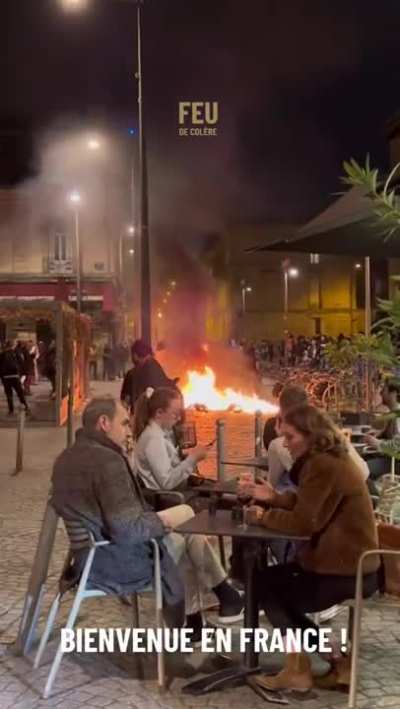 Enjoying themselves at a cafe in the middle of the french protest